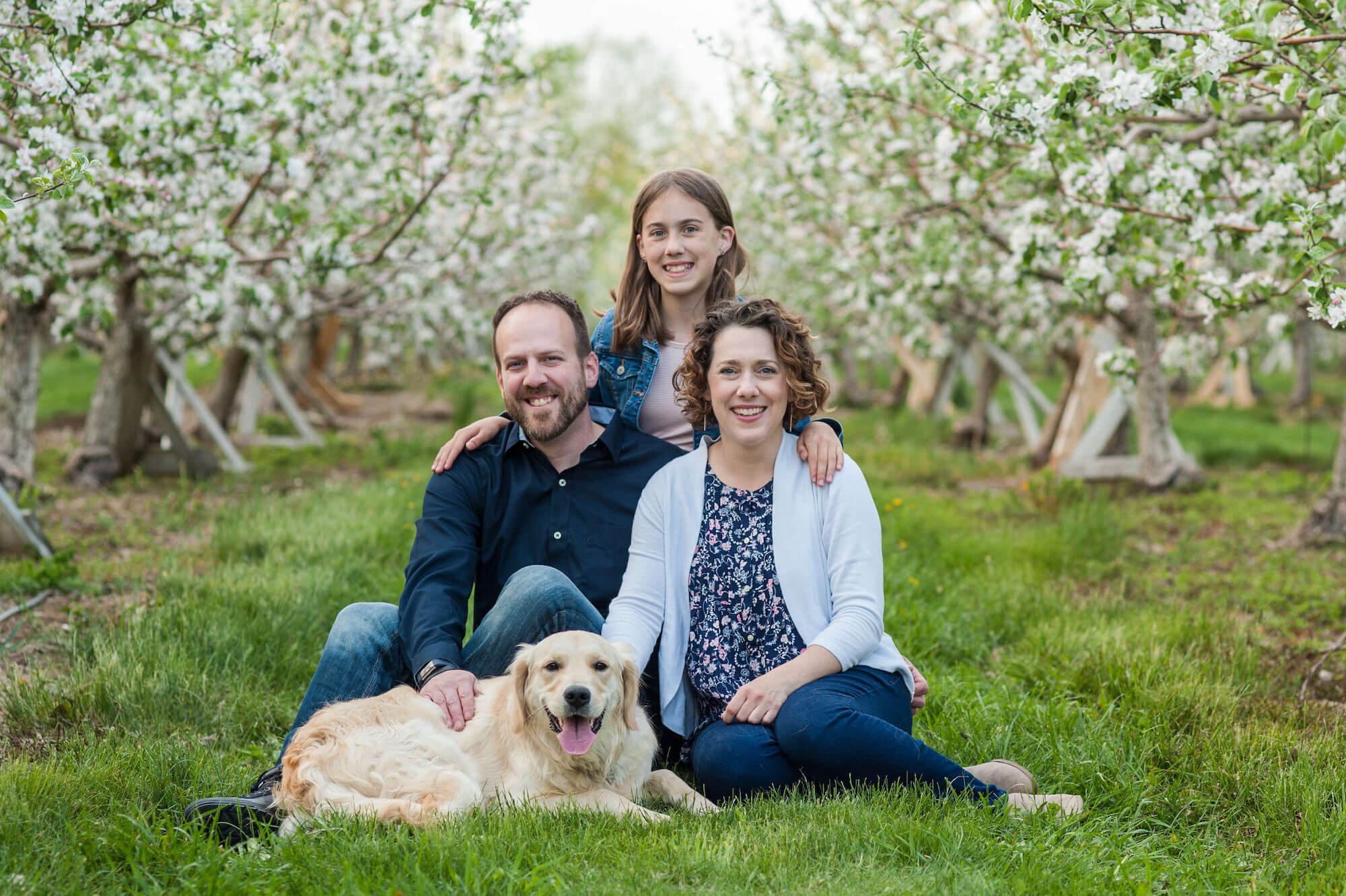 Esther Littlefield with family with apple orchard blossoms